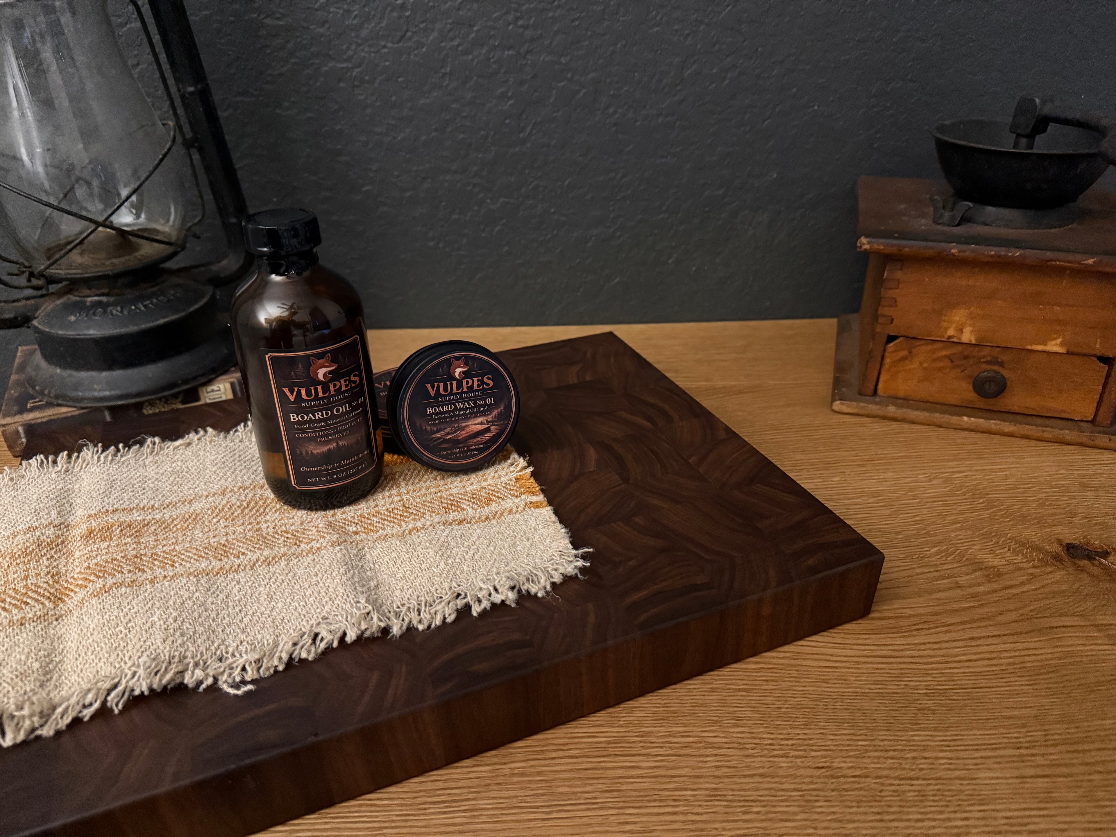 Field Board No. 2 patterned walnut end-grain cutting board displayed with Vulpes Board Oil No. 1 and Board Wax No. 1.